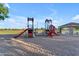 Community playground with slides, climbing structures, and a shaded picnic area for Gathering fun at 13304 W Palo Verde Dr, Litchfield Park, AZ 85340