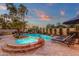 Relaxing backyard oasis with a sparkling pool, spa, waterfall feature and lounge chairs at 1356 E Flamingo Ct, Gilbert, AZ 85297
