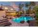 Resort-style backyard with a pool, spa, mature palm trees, and outdoor seating at 1356 E Flamingo Ct, Gilbert, AZ 85297