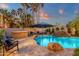 Beautiful backyard oasis with a freeform pool, rock waterfall feature, and lush landscaping at 1356 E Flamingo Ct, Gilbert, AZ 85297