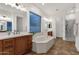 Large bathroom with soaking tub, double sinks, and separate tiled shower at 1356 E Flamingo Ct, Gilbert, AZ 85297