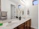 Bathroom features double sinks, neutral countertops, updated faucets, and a large mirror at 1356 E Flamingo Ct, Gilbert, AZ 85297