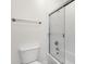 Bathroom featuring white toilet, towel rack, and a glass door enclosing the shower and bathtub at 1356 E Flamingo Ct, Gilbert, AZ 85297