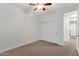 Carpeted bedroom with a closet, white walls, and ceiling fan at 1356 E Flamingo Ct, Gilbert, AZ 85297
