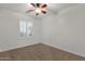 Carpeted bedroom with a ceiling fan and window with plantation shutters at 1356 E Flamingo Ct, Gilbert, AZ 85297