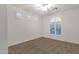 Carpeted bedroom with white walls and arched window with plantation shutters at 1356 E Flamingo Ct, Gilbert, AZ 85297