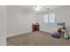 Empty bedroom with carpet, ceiling fan, window with blinds, and a toy shelf at 1356 E Flamingo Ct, Gilbert, AZ 85297