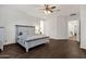 Inviting bedroom featuring hardwood floors, a ceiling fan, neutral wall color, and a comfortable bed with decor at 1356 E Flamingo Ct, Gilbert, AZ 85297