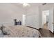Bright bedroom with wood floors, ceiling fan, and closet and bathroom access at 1356 E Flamingo Ct, Gilbert, AZ 85297