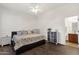 Bright bedroom featuring wood floors, ceiling fan, and en-suite bathroom access at 1356 E Flamingo Ct, Gilbert, AZ 85297