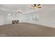 Bright bonus room with carpet, white walls, ceiling fans, and plenty of natural light at 1356 E Flamingo Ct, Gilbert, AZ 85297