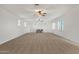 Expansive bonus room offers neutral carpet, white walls, natural light, and storage at 1356 E Flamingo Ct, Gilbert, AZ 85297