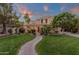 Inviting two-story home featuring lush landscaping, a brick walkway, and a welcoming front porch at 1356 E Flamingo Ct, Gilbert, AZ 85297