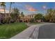 Elegant two-story home featuring lush landscaping, mature trees, and a curved walkway leading to the entrance at 1356 E Flamingo Ct, Gilbert, AZ 85297