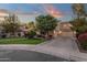 Elegant home with a spacious three-car garage and a beautifully landscaped front yard with lush greenery at 1356 E Flamingo Ct, Gilbert, AZ 85297