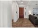 Bright entryway showcasing tile floors, a wooden front door, and a glimpse into the adjacent living area at 1356 E Flamingo Ct, Gilbert, AZ 85297