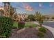 Beautifully landscaped front yard featuring vibrant flowers, decorative rocks and lush green lawn at 1356 E Flamingo Ct, Gilbert, AZ 85297