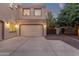 Three-car garage features exterior lighting, new garage doors and extra parking space at 1356 E Flamingo Ct, Gilbert, AZ 85297