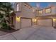 Spacious three-car garage with ample parking space, featuring modern doors and exterior lighting at 1356 E Flamingo Ct, Gilbert, AZ 85297