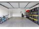 Clean and spacious garage with epoxy flooring, ideal for parking and storage, features shelving and space for bicycles at 1356 E Flamingo Ct, Gilbert, AZ 85297