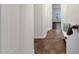 Inviting hallway with tile flooring, white walls, and a charming white bench topped with throw blanket and pillow at 1356 E Flamingo Ct, Gilbert, AZ 85297