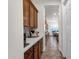 Long hallway with tile floor and lots of cabinets leading to kitchen at 1356 E Flamingo Ct, Gilbert, AZ 85297