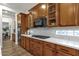 Kitchen with wood cabinets, white countertops and backsplash, and stainless steel appliances at 1356 E Flamingo Ct, Gilbert, AZ 85297