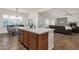 Kitchen island featuring a stainless steel sink and faucet with seating for three at 1356 E Flamingo Ct, Gilbert, AZ 85297