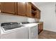 Functional laundry room with washer, dryer, sink, and ample cabinet space at 1356 E Flamingo Ct, Gilbert, AZ 85297