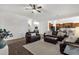 Open living room with dark wood floors, lots of natural light, and leather furniture at 1356 E Flamingo Ct, Gilbert, AZ 85297