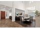 Open-concept living and dining area featuring high ceilings, plantation shutters, and modern chandelier at 1356 E Flamingo Ct, Gilbert, AZ 85297