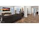 Comfortable living room showcasing a stylish sofa, wooden floors, and an open layout to the dining space at 1356 E Flamingo Ct, Gilbert, AZ 85297