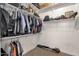 Spacious walk-in closet with shelves, rods, and carpet flooring for organized storage at 1356 E Flamingo Ct, Gilbert, AZ 85297