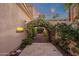 Charming walkway with flowering archway leads to a serene garden, creating a private and tranquil outdoor space at 1356 E Flamingo Ct, Gilbert, AZ 85297