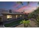 Cozy backyard with grassy area, pavers, and desert landscaping at 14234 N 26Th Ln, Phoenix, AZ 85023