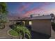 Backyard view with desert landscaping, trees, and an enclosed patio at 14234 N 26Th Ln, Phoenix, AZ 85023