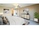 Serene bedroom featuring modern decor, a ceiling fan, and a seamless transition to the ensuite bathroom at 14234 N 26Th Ln, Phoenix, AZ 85023