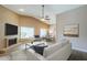 Bright living room with fireplace open to the dining area, seamlessly blending comfort and sophistication at 14234 N 26Th Ln, Phoenix, AZ 85023