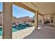 Outdoor oasis features a pool, spa, covered patio, and artificial grass at 15731 W Redfield Rd, Surprise, AZ 85379