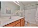 Bathroom featuring a single sink vanity, large mirror, and a shower-tub combination at 15731 W Redfield Rd, Surprise, AZ 85379