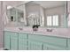 Bathroom features a double sink vanity with pale green cabinets and large mirror at 15731 W Redfield Rd, Surprise, AZ 85379