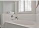 Bright bathroom features a white soaking tub with a view of the window at 15731 W Redfield Rd, Surprise, AZ 85379