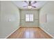 Spacious, empty bedroom with wood floors, ceiling fan, and neutral paint at 15731 W Redfield Rd, Surprise, AZ 85379
