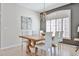 Bright dining room featuring a wooden table with white chairs and a stylish chandelier at 15731 W Redfield Rd, Surprise, AZ 85379