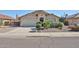 Inviting single-story home with a well-maintained front yard and an attached two-car garage at 15731 W Redfield Rd, Surprise, AZ 85379