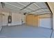 Well-maintained garage with epoxy floor and built-in storage cabinets at 15731 W Redfield Rd, Surprise, AZ 85379