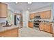 Well-lit kitchen with stainless steel refrigerator and appliances, plus ample counter space at 15731 W Redfield Rd, Surprise, AZ 85379