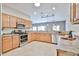 Spacious kitchen with stainless steel appliances, wooden cabinets, and tile flooring at 15731 W Redfield Rd, Surprise, AZ 85379