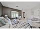 Comfortable living room with neutral tones, tiled floors, and ample natural light at 15731 W Redfield Rd, Surprise, AZ 85379