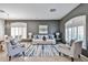 Spacious living room with comfortable seating, neutral colors, and ample natural light at 15731 W Redfield Rd, Surprise, AZ 85379